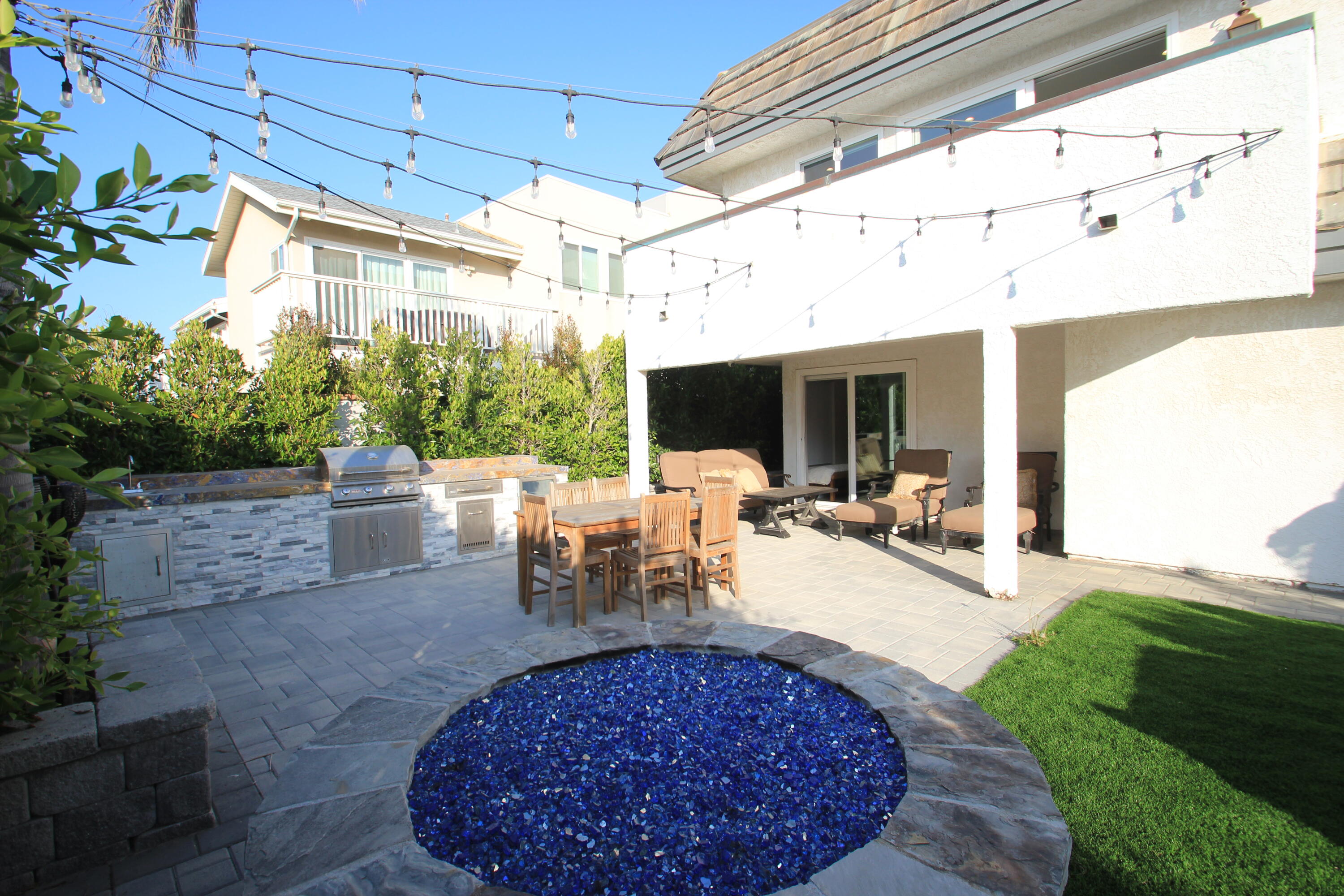 5235 Sealane Way Oxnard, CA 93035 - Photo 41 of 57 a view of a patio with table and chairs potted plants and floor to ceiling window