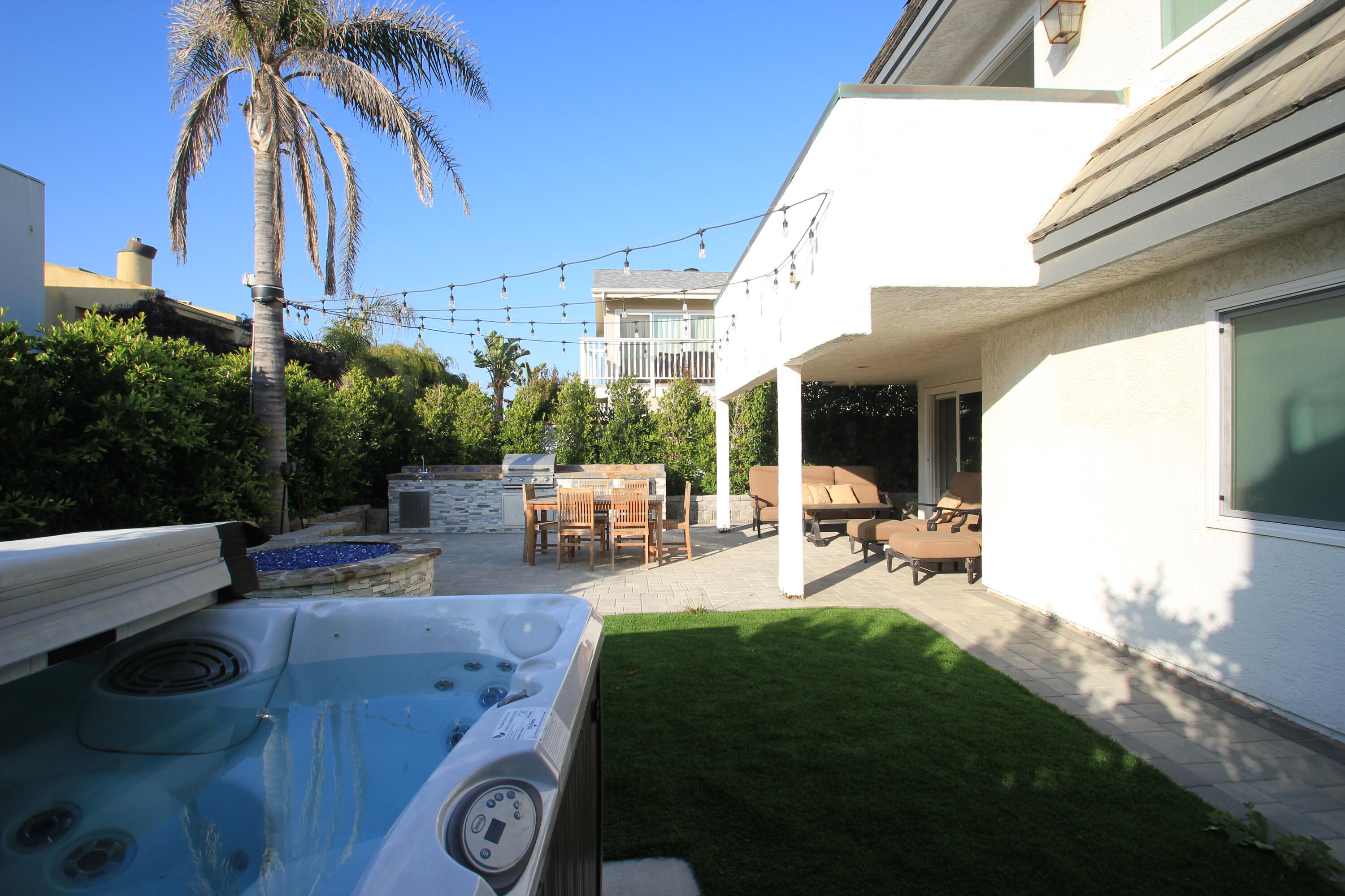5235 Sealane Way Oxnard, CA 93035 - Photo 42 of 57 a view of a patio with couches and a table and chairs under an umbrella