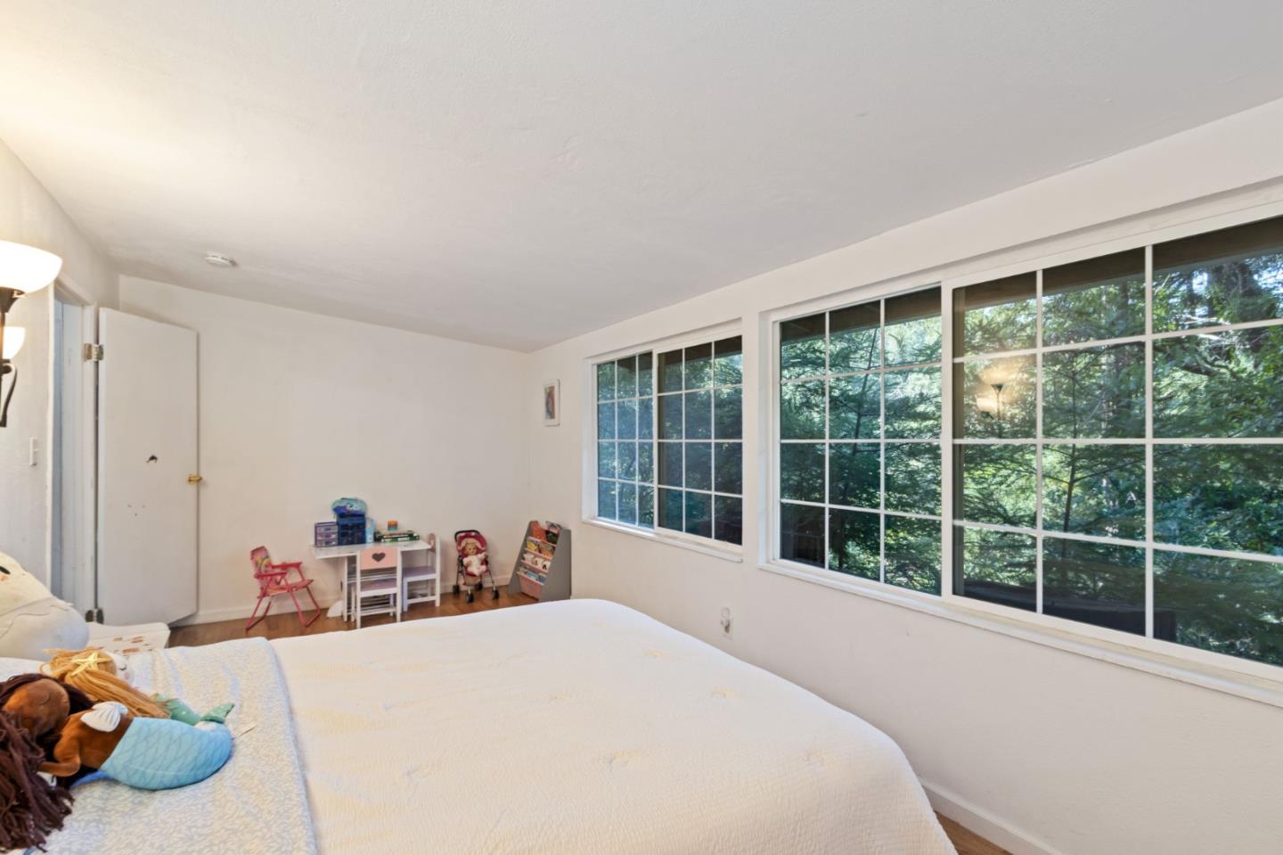 320 Fireside Road Boulder Creek, CA 95006 - Photo 20 of 36 a bed room with a bed and a large window