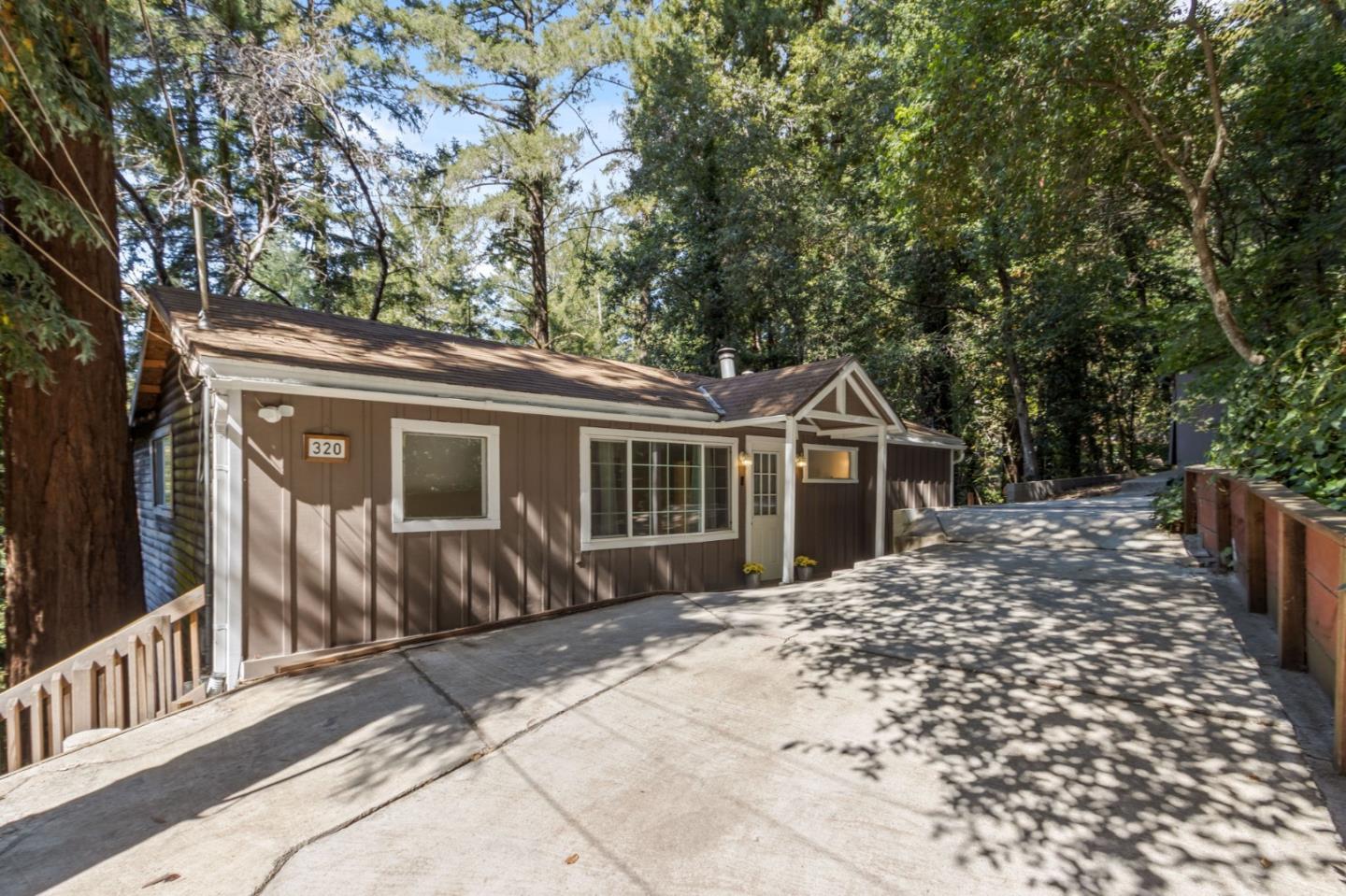 320 Fireside Road Boulder Creek, CA 95006 - Photo 2 of 36 a front view of a house with a yard and potted plants