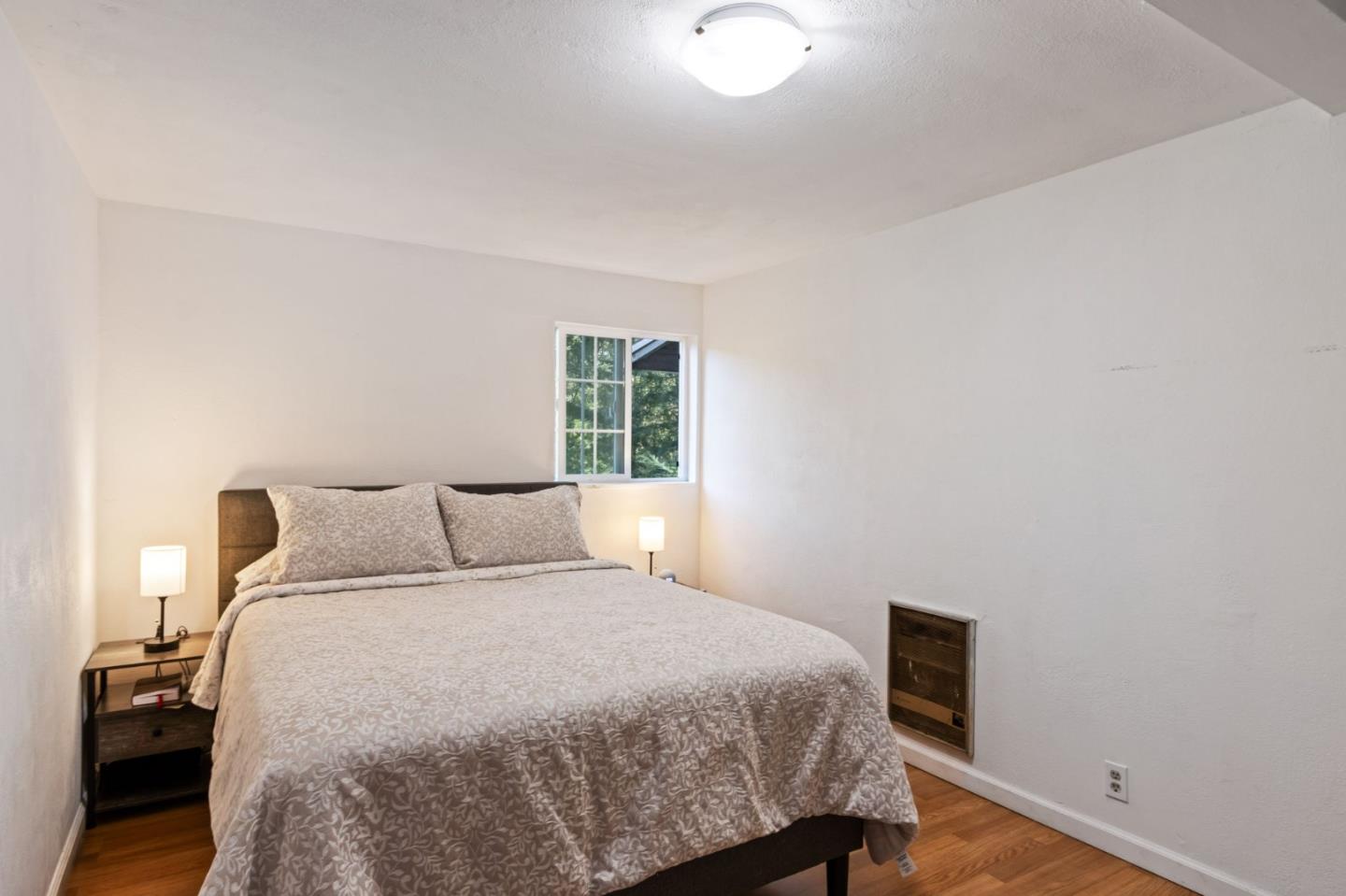 320 Fireside Road Boulder Creek, CA 95006 - Photo 21 of 36 a bedroom with a bed and a window