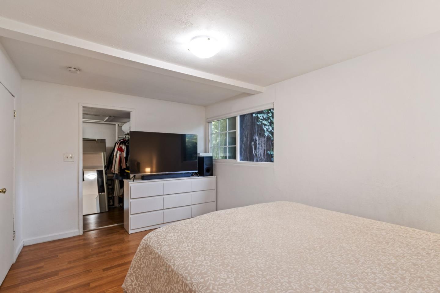 320 Fireside Road Boulder Creek, CA 95006 - Photo 23 of 36 a bedroom with a bed and a flat screen tv