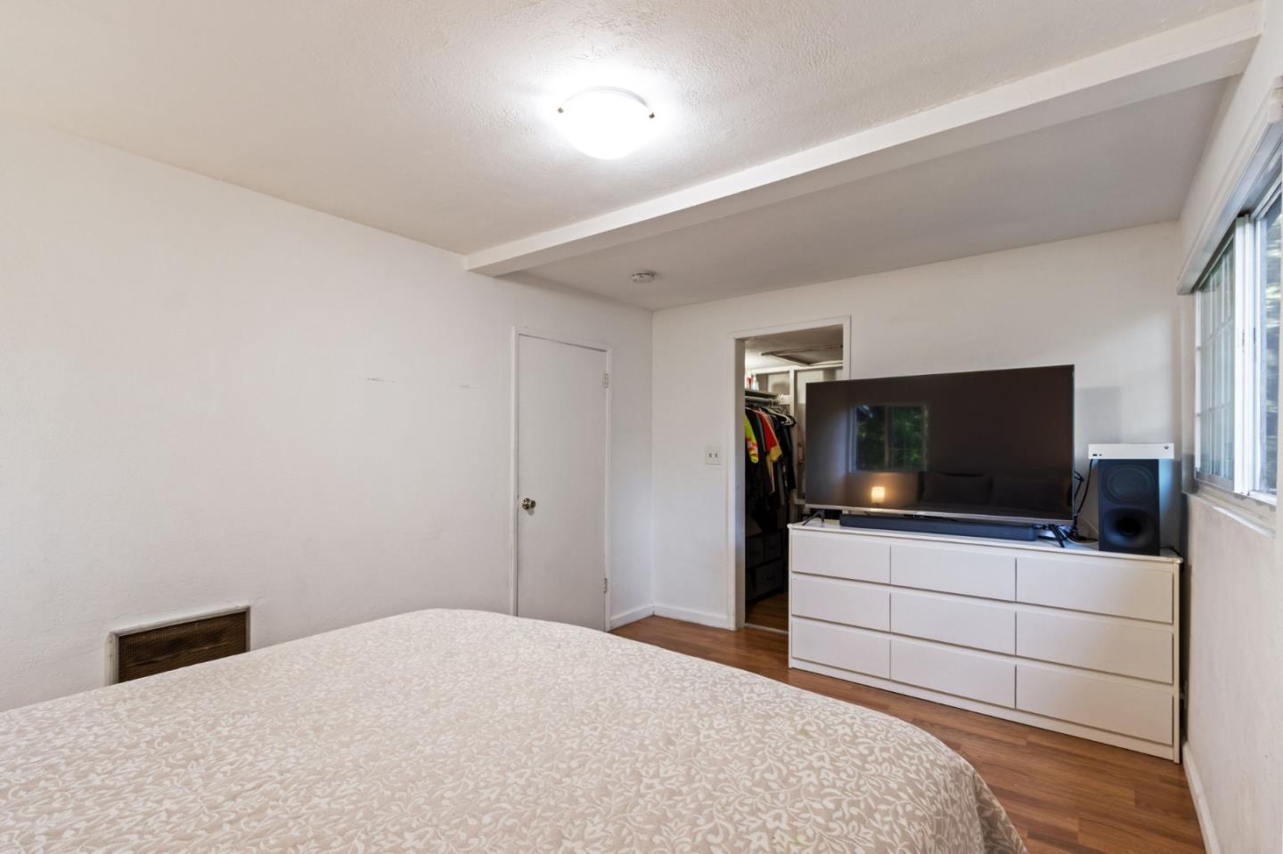 320 Fireside Road Boulder Creek, CA 95006 - Photo 24 of 36 a bedroom with a bed and a flat screen tv