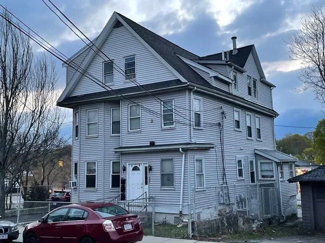 a front view of a house with parking space