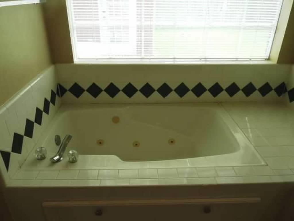 4542 Springfield Lakes Street Sugar Land, TX 77479 - Photo 12 of 16 Relaxing garden tub in the primary bath, perfect for unwinding after a long day.