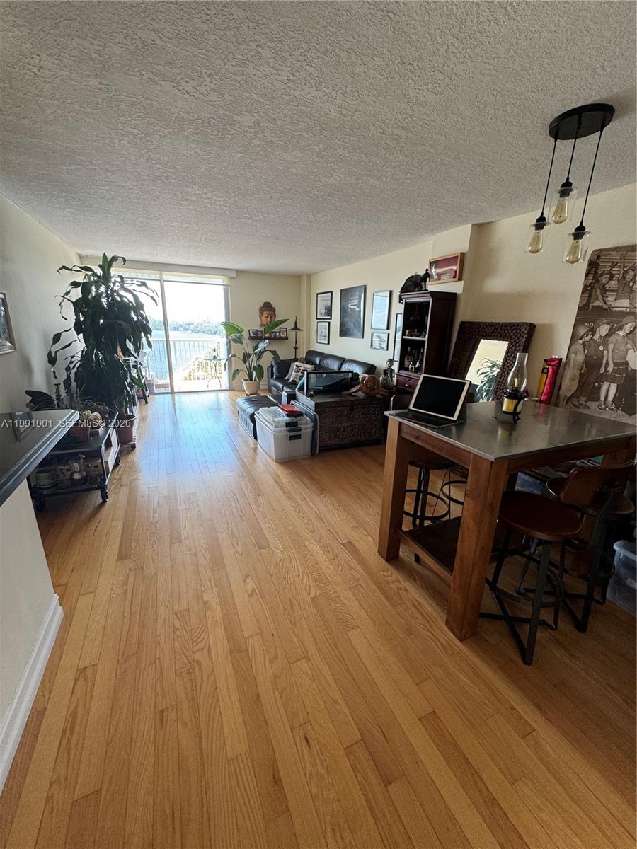 150 Southeast 25th Road, Unit 11L Miami, FL 33129 - Photo 3 of 11 a living room with furniture and a wooden floor