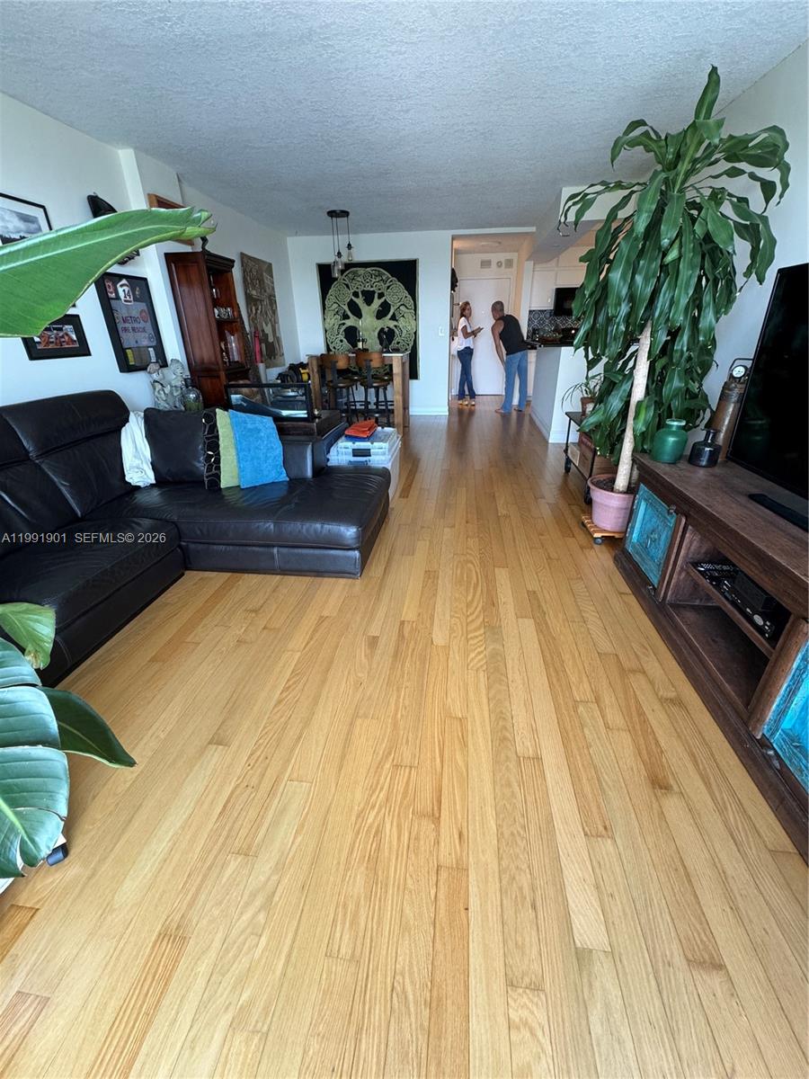 150 Southeast 25th Road, Unit 11L Miami, FL 33129 - Photo 4 of 11 a living room with patio area