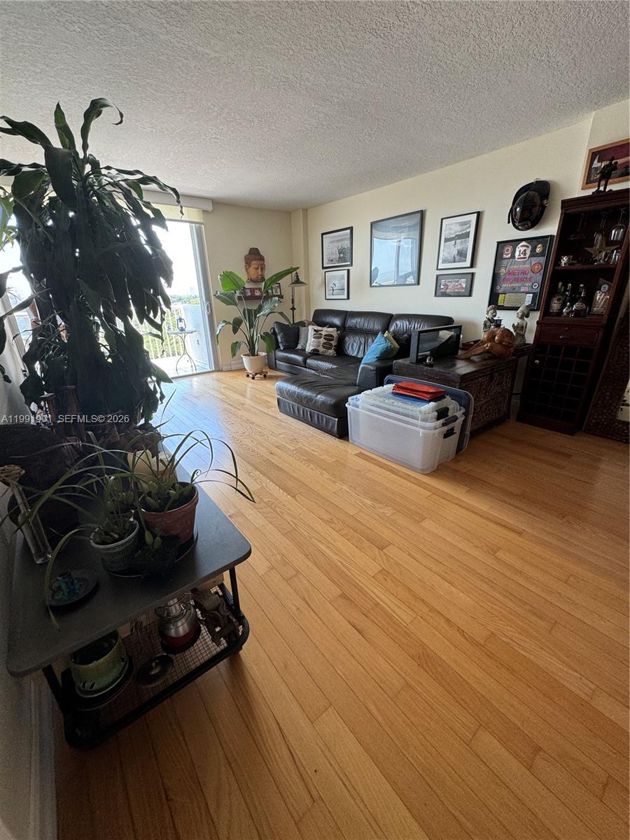 150 Southeast 25th Road, Unit 11L Miami, FL 33129 - Photo 5 of 11 a living room with furniture and a wooden floor