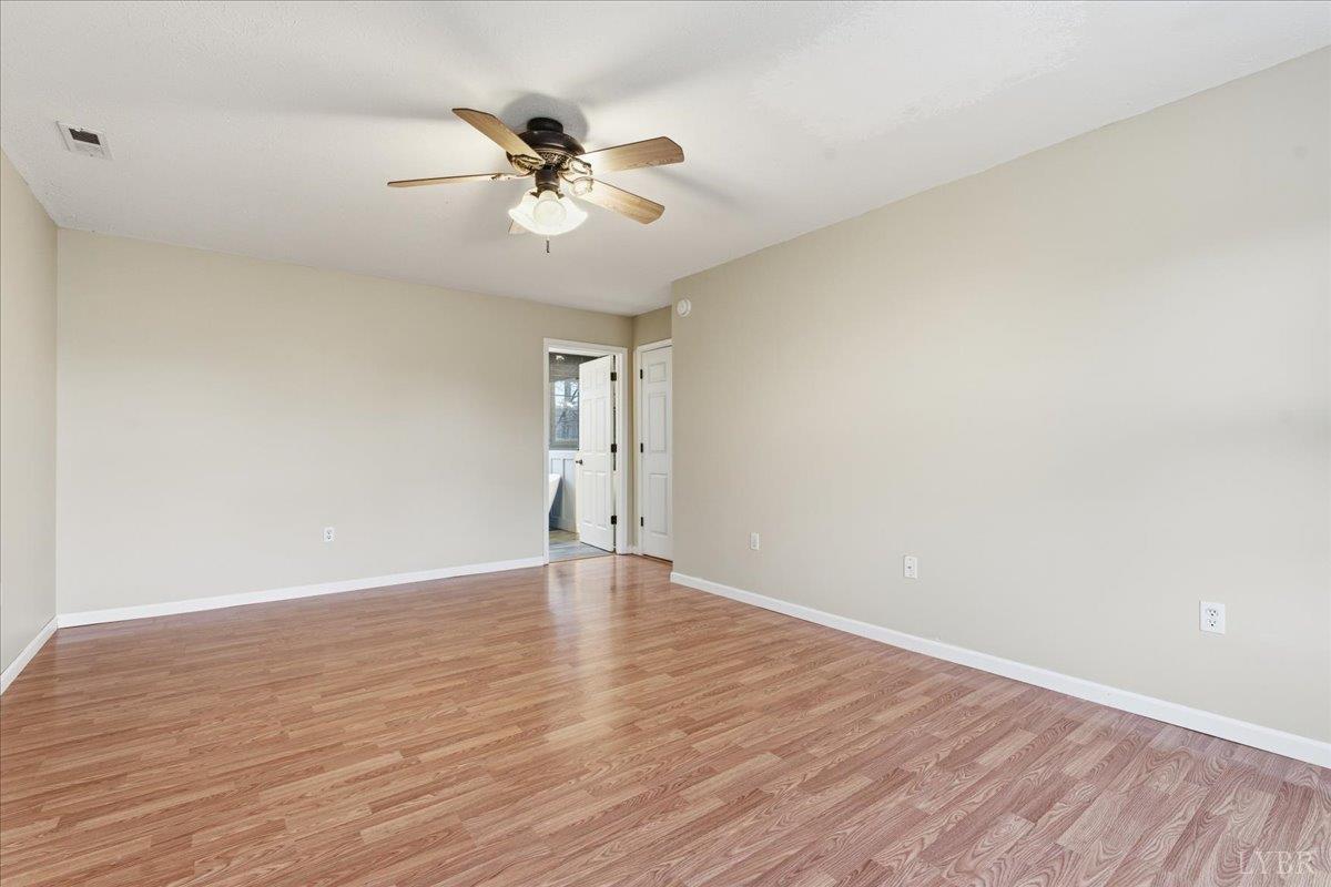 1329 Jeb Stuart Place Forest, VA 24551 - Photo 24 of 60 a view of an empty room with wooden floor and a chandelier fan