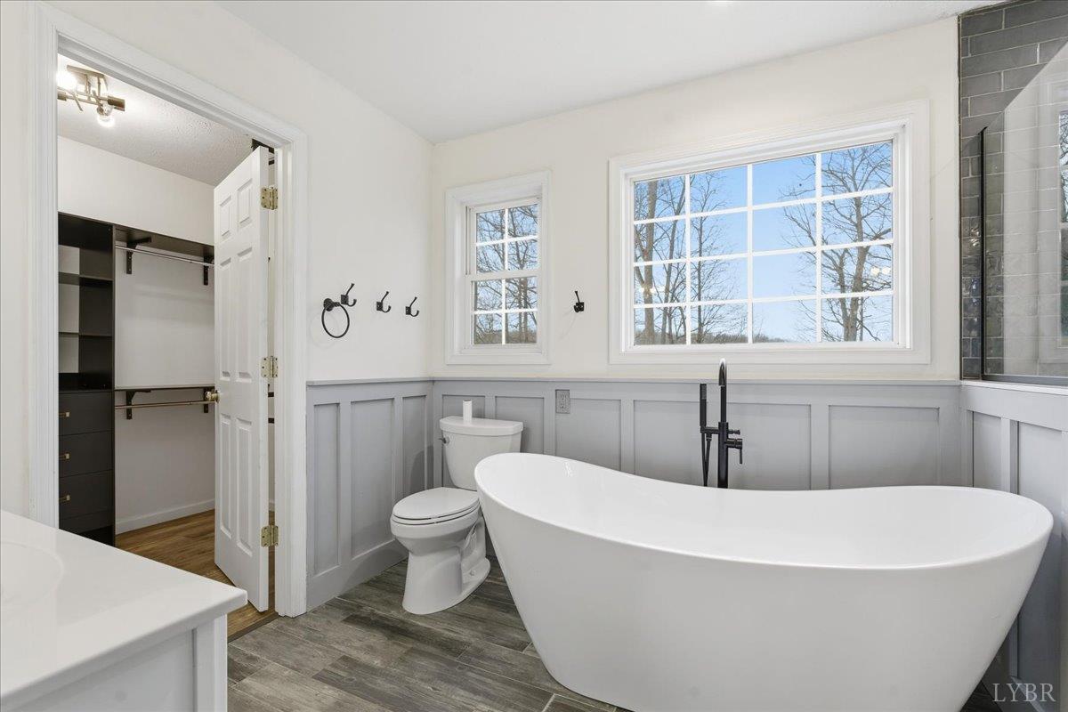 1329 Jeb Stuart Place Forest, VA 24551 - Photo 25 of 60 a white bath tub sitting next to a white toilet