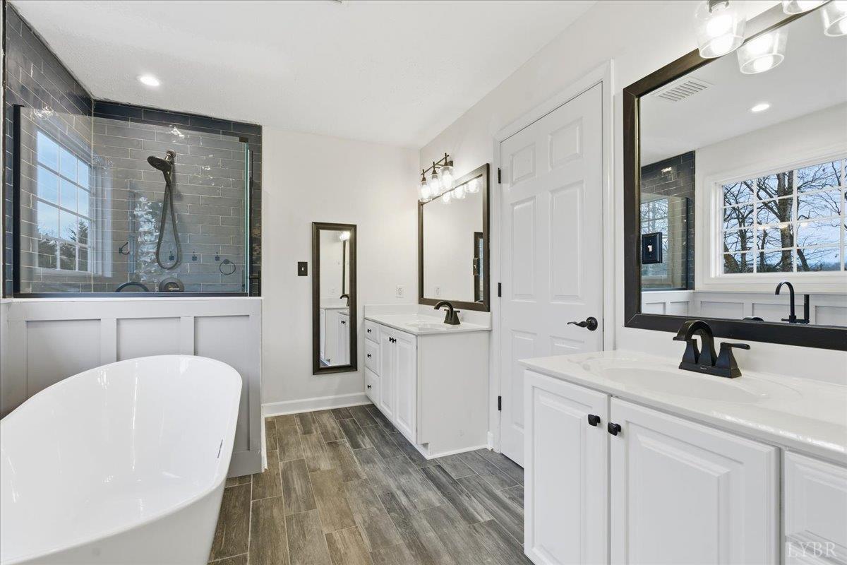 1329 Jeb Stuart Place Forest, VA 24551 - Photo 26 of 60 a bathroom with a double vanity sink mirror and bathtub