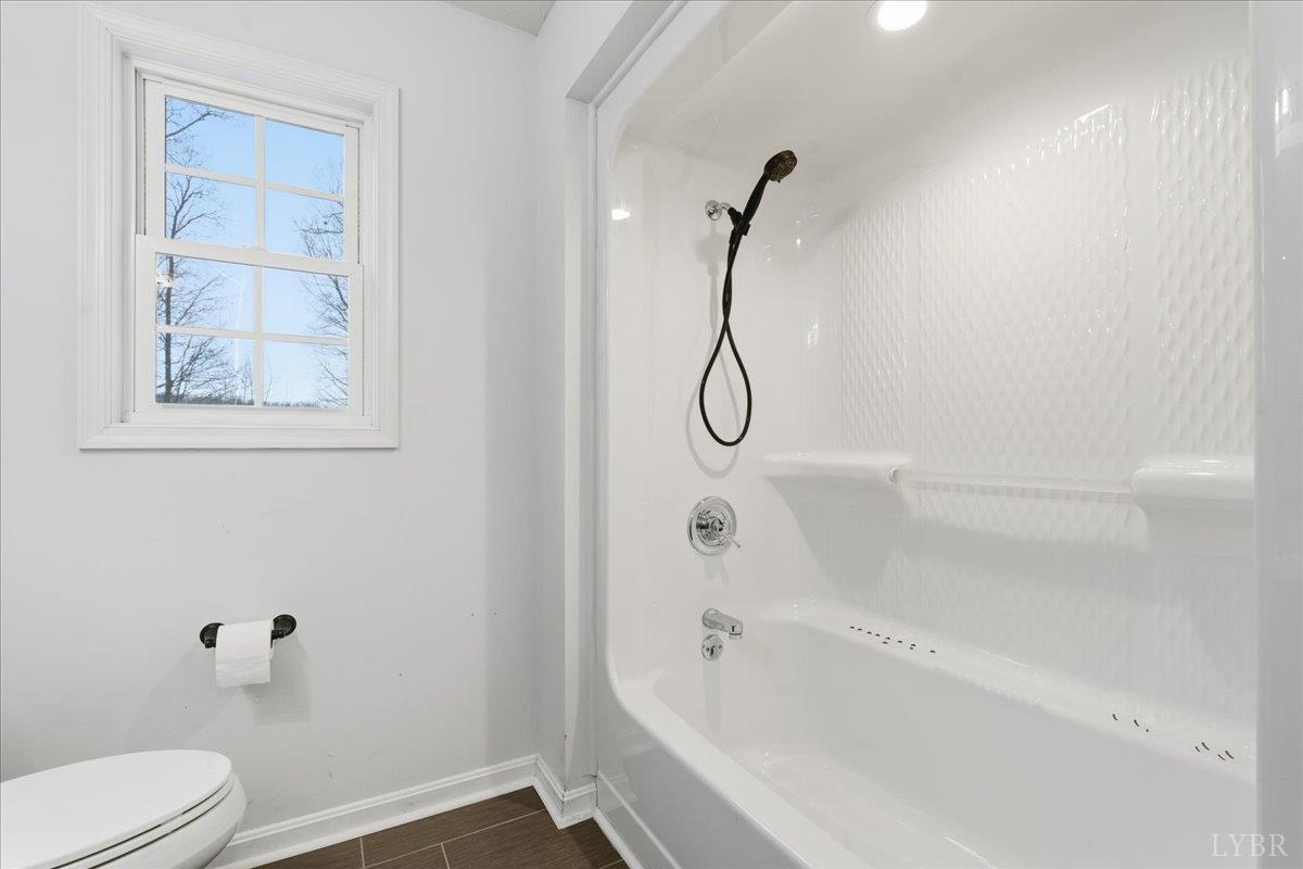 1329 Jeb Stuart Place Forest, VA 24551 - Photo 33 of 60 a bathroom with a granite countertop bathtub shower and toilet