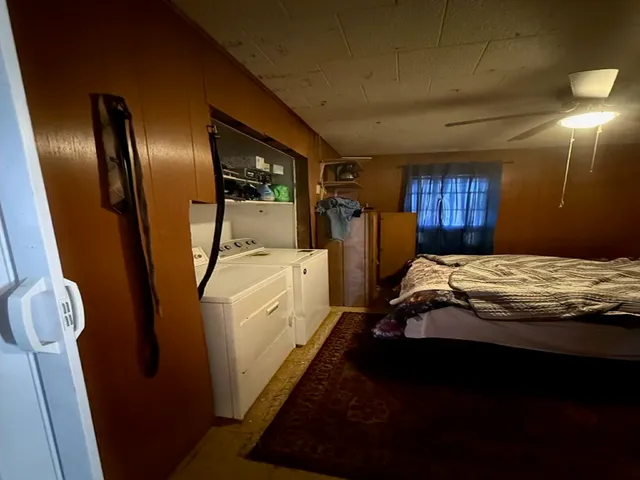 a bed sitting in a bedroom next to a window