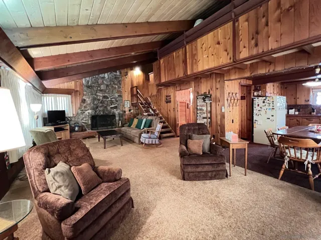 a living room with furniture a fireplace and a large window
