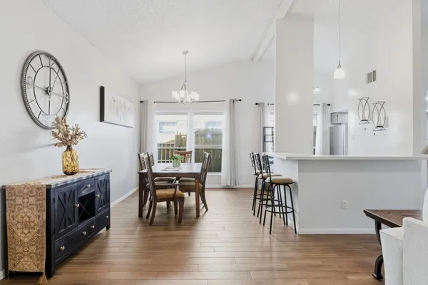a view of a kitchen with dining table and chairs