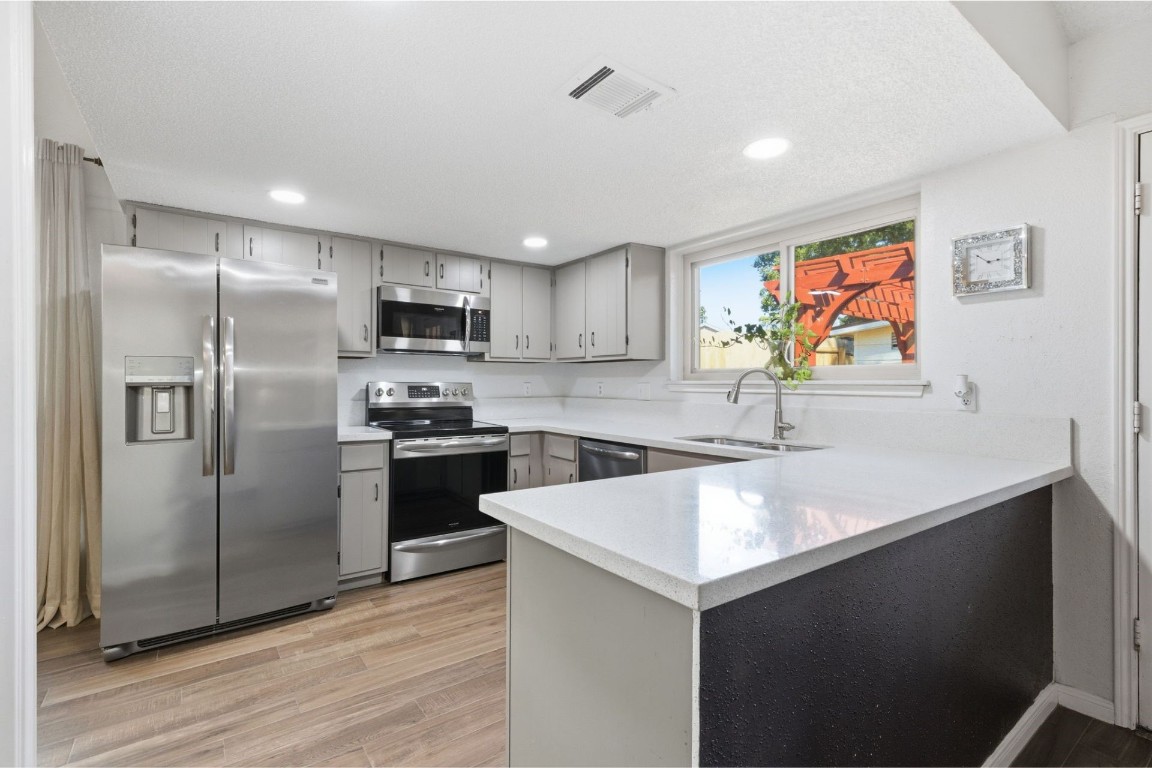 17522 Hunters Glen Circle Humble, TX 77396 - Photo 6 of 14 a kitchen with granite countertop a refrigerator and a sink