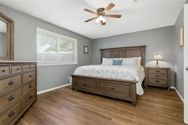 a bedroom with a bed and a chandelier