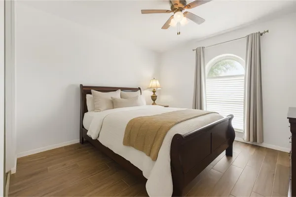 a bedroom with a bed and a window