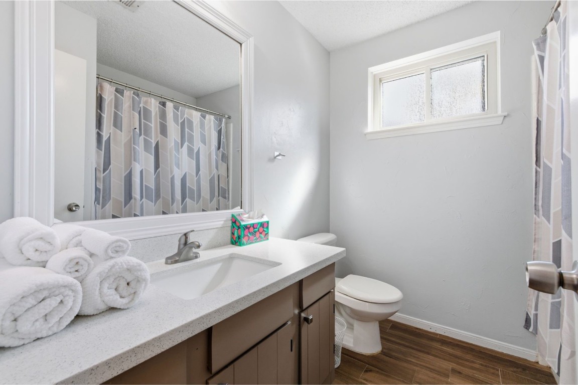 17522 Hunters Glen Circle Humble, TX 77396 - Photo 10 of 14 a bathroom with a granite countertop sink a toilet and a window