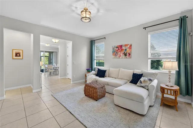 a dining room with furniture and a large window