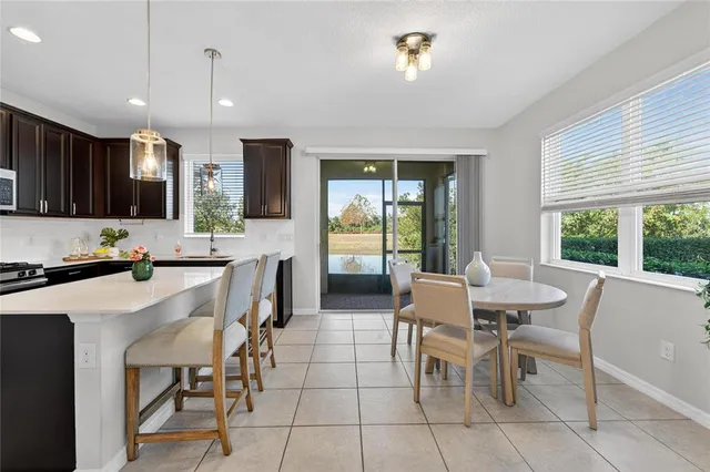 an empty room with chandelier fan and windows