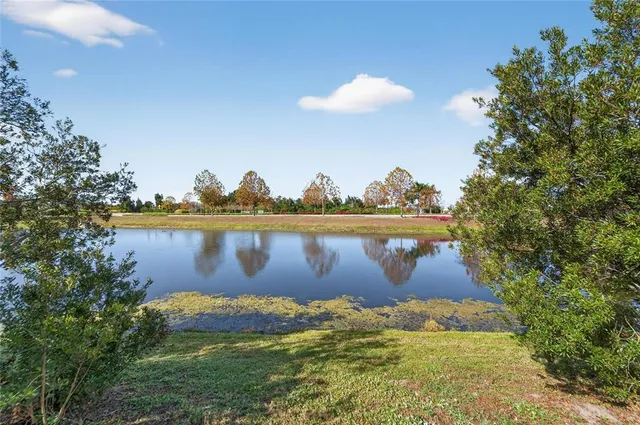 a view of a lake with houses in the back