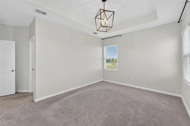 an aerial view of residential houses with outdoor space and ocean view