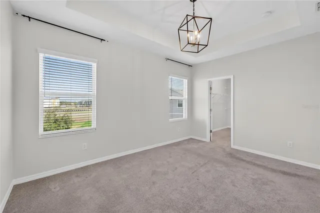an aerial view of residential houses with outdoor space and ocean view