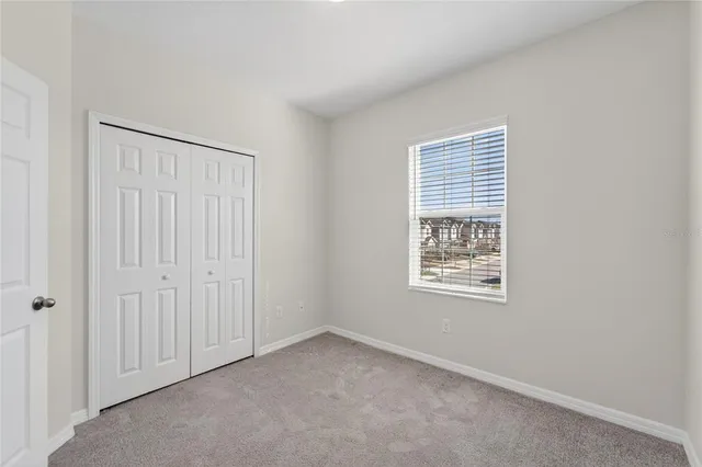 an aerial view of multiple houses with a lake view