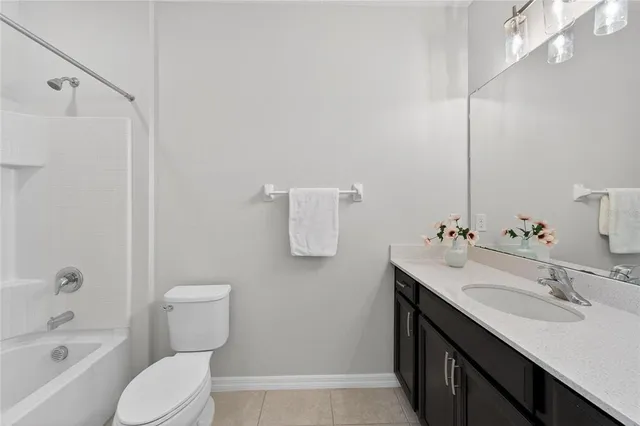 an aerial view of a house with a swimming pool and a yard