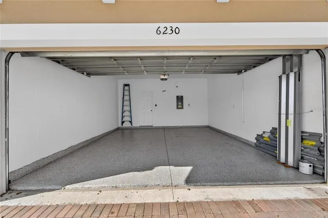 an aerial view of a house with a yard and green space