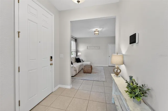 a living room with furniture and a wall painting