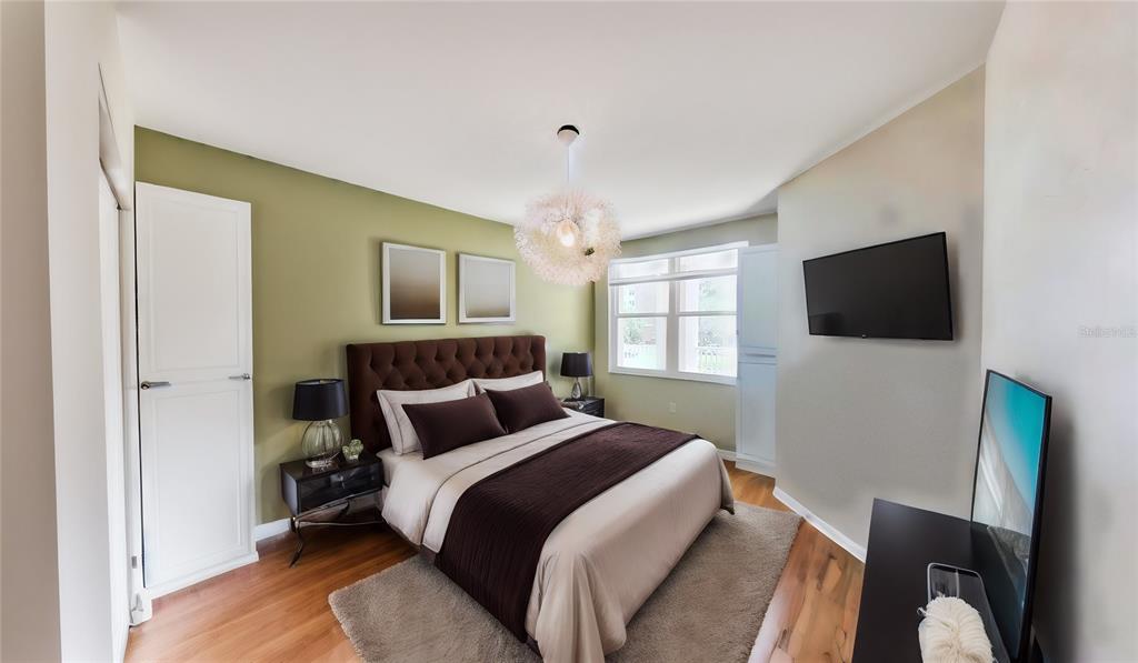 6495 Shoreline Drive, Unit 8104 St. Petersburg, FL 33708 - Photo 11 of 70 a bedroom with a bed tv and a window