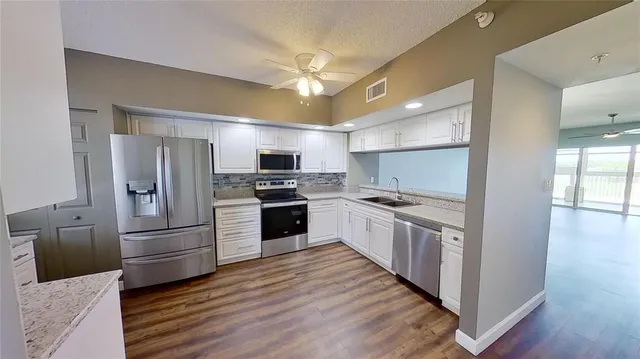 a kitchen with stainless steel appliances a stove microwave and cabinets