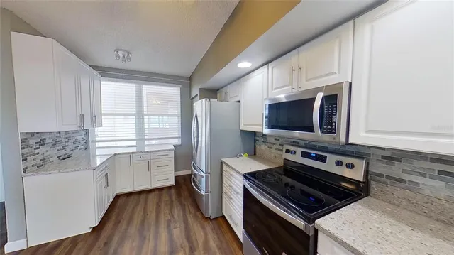 a view of a room with wooden floor fan and window