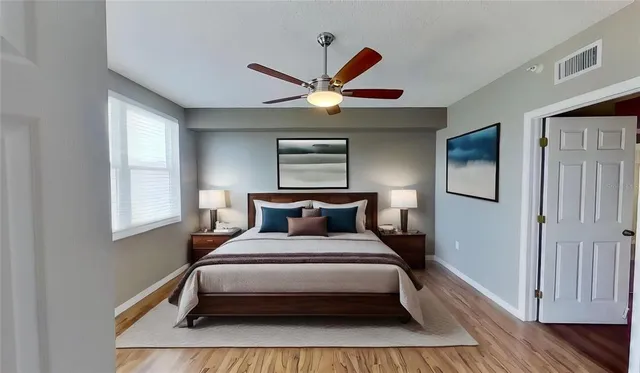 a bed sitting in a bedroom next to a window