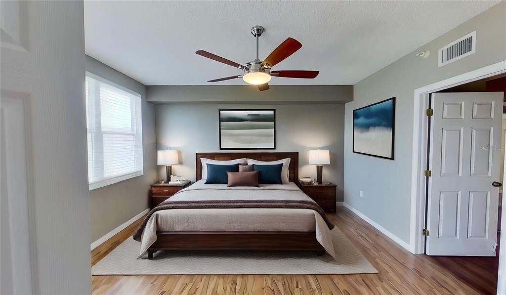 6495 Shoreline Drive, Unit 8104 St. Petersburg, FL 33708 - Photo 3 of 70 a bed sitting in a bedroom next to a window