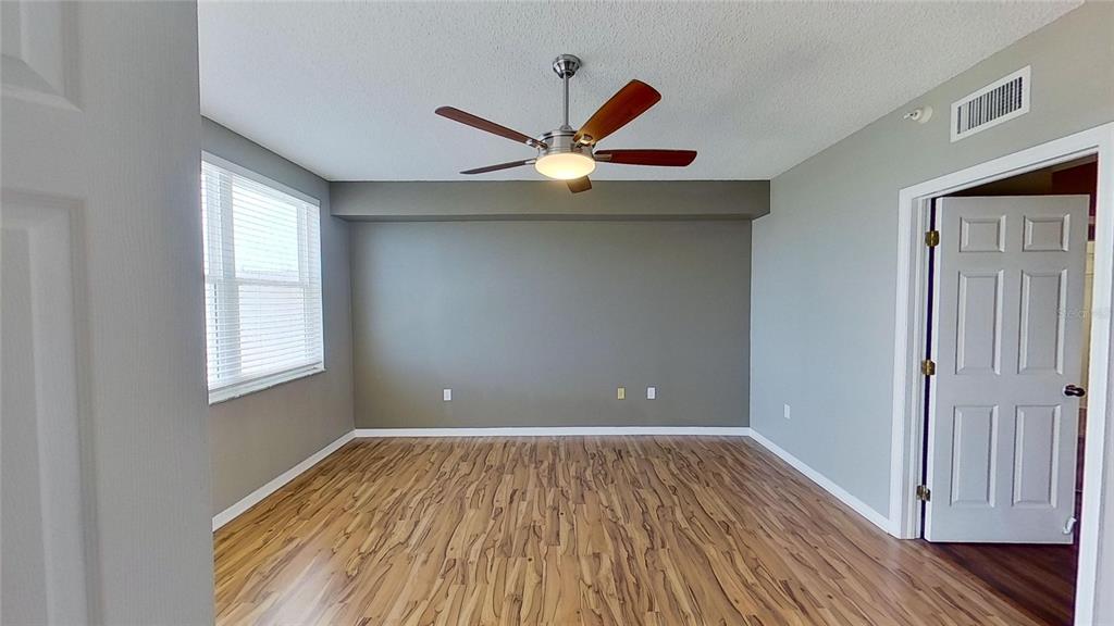 6495 Shoreline Drive, Unit 8104 St. Petersburg, FL 33708 - Photo 35 of 70 a view of an empty room with window and wooden floor