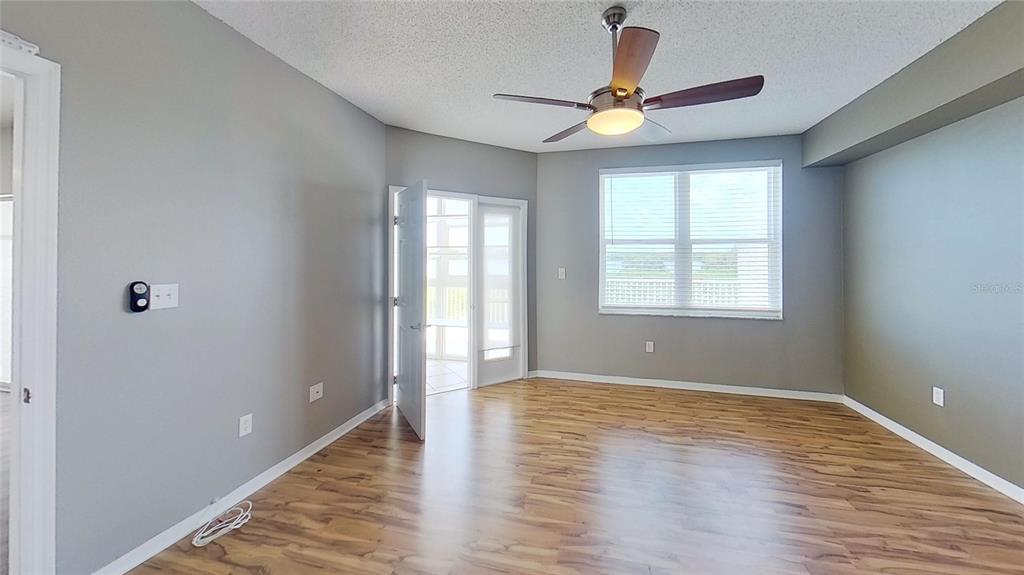 6495 Shoreline Drive, Unit 8104 St. Petersburg, FL 33708 - Photo 37 of 70 a view of an empty room with window and wooden floor