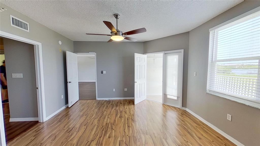 6495 Shoreline Drive, Unit 8104 St. Petersburg, FL 33708 - Photo 38 of 70 a view of empty room with wooden floor and fan