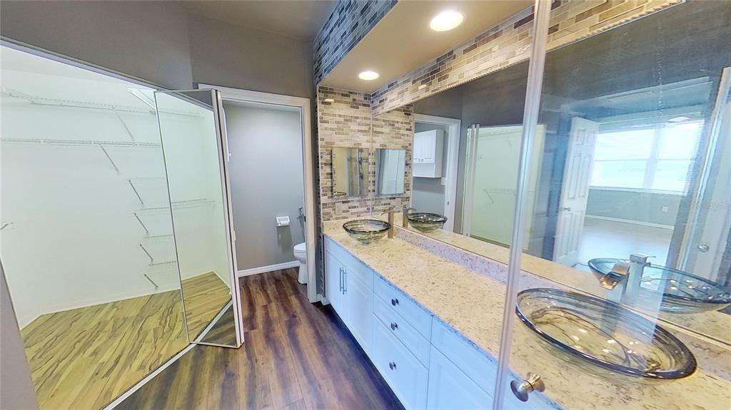 6495 Shoreline Drive, Unit 8104 St. Petersburg, FL 33708 - Photo 40 of 70 a bathroom with a granite countertop sink and a mirror