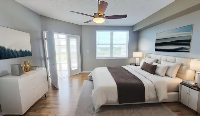 a bedroom with bed tv and window