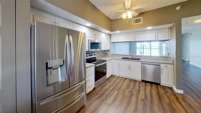 a kitchen with a refrigerator a sink and dishwasher