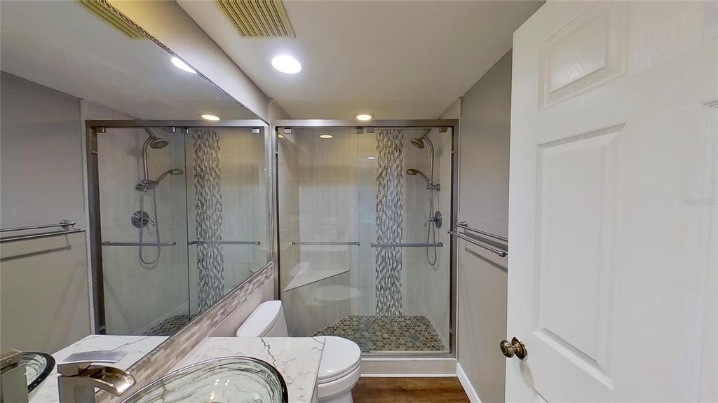 6495 Shoreline Drive, Unit 8104 St. Petersburg, FL 33708 - Photo 51 of 70 a bathroom with a shower and a toilet