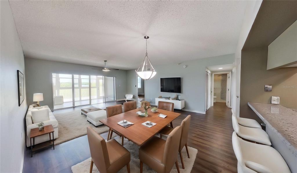 6495 Shoreline Drive, Unit 8104 St. Petersburg, FL 33708 - Photo 7 of 70 a view of a dining room with furniture window and wooden floor