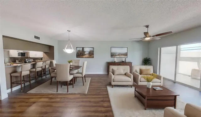 a living room with furniture and wooden floor