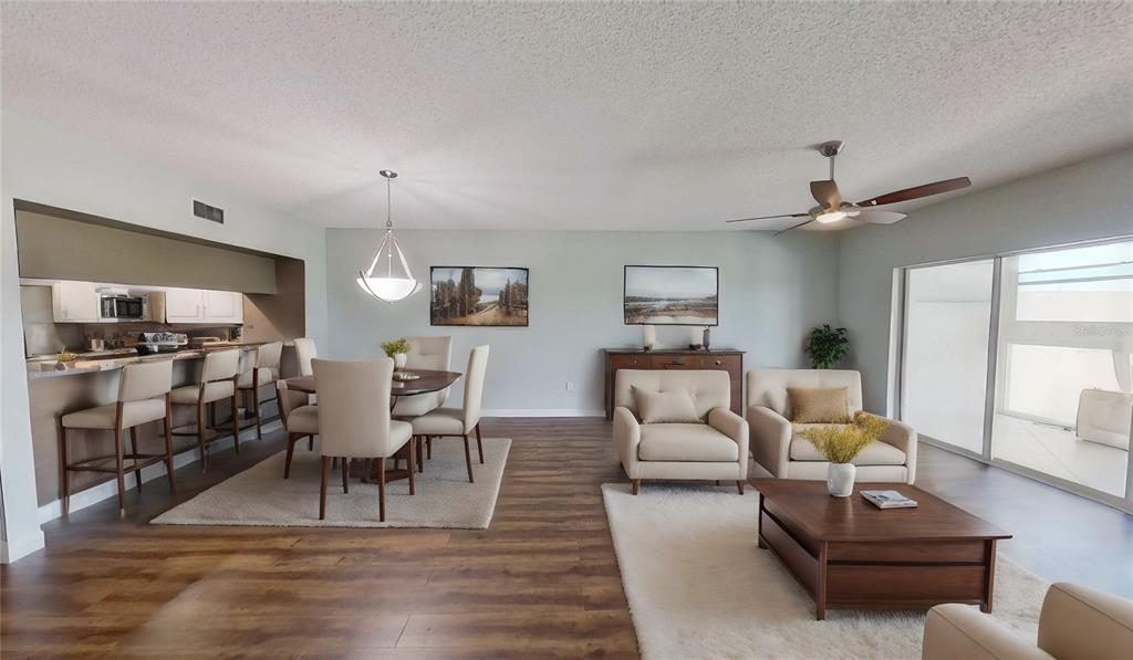 6495 Shoreline Drive, Unit 8104 St. Petersburg, FL 33708 - Photo 9 of 70 a living room with furniture and wooden floor
