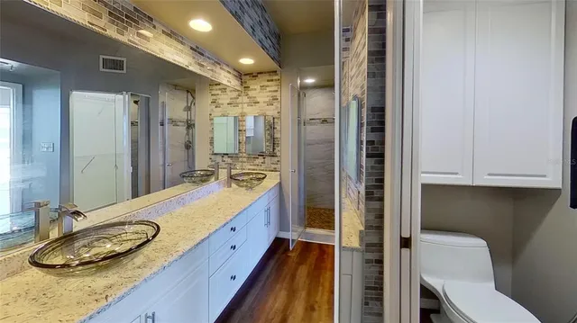a bathroom with a granite countertop sink and a mirror
