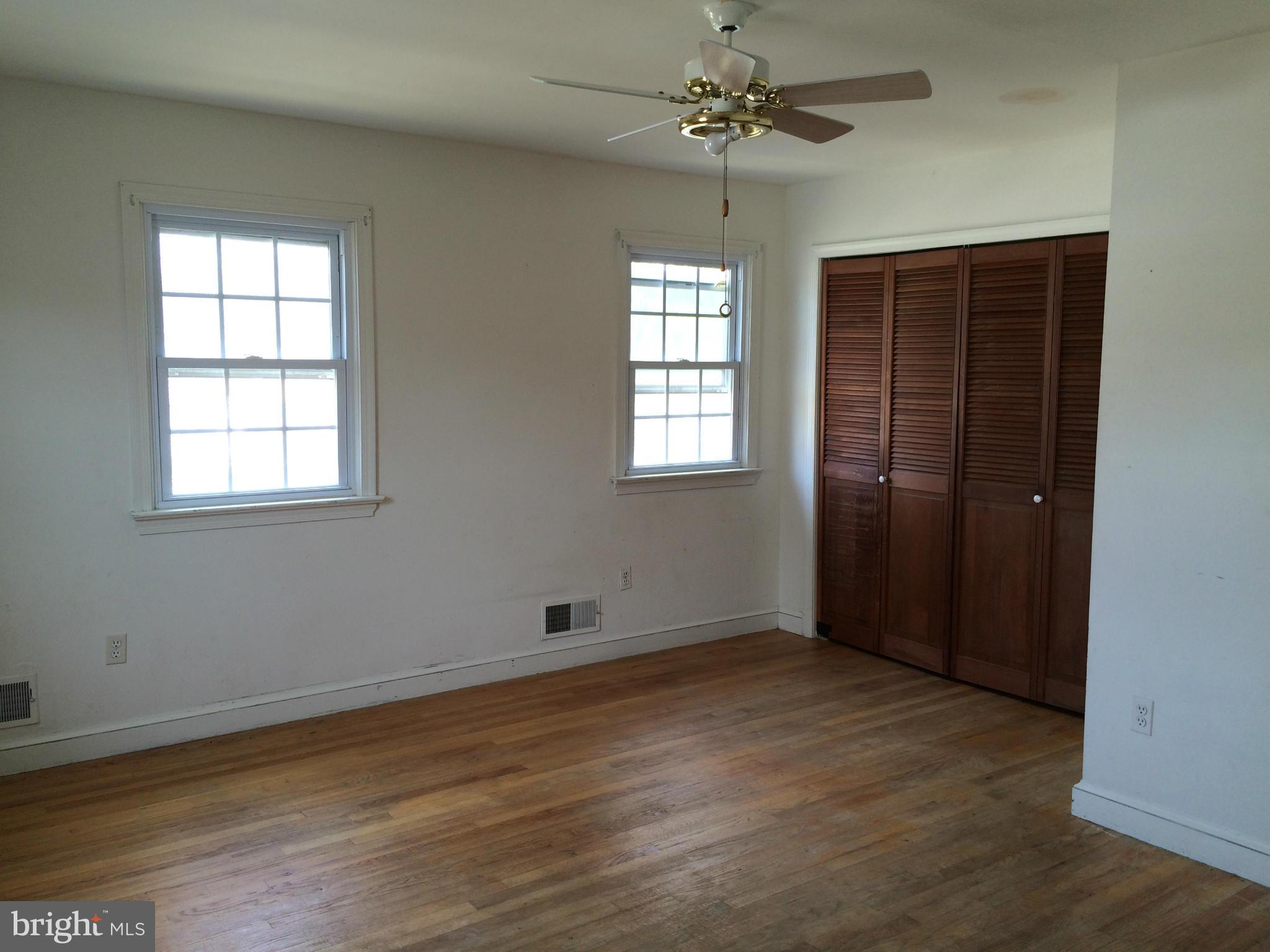 3704 Fairly Street Silver Spring, MD 20906 - Photo 14 of 24 an empty room with wooden floor chandelier fan and windows