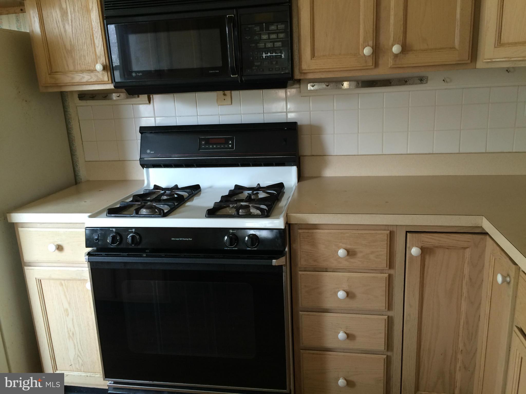 3704 Fairly Street Silver Spring, MD 20906 - Photo 7 of 24 a kitchen with granite countertop cabinets and steel stove top oven